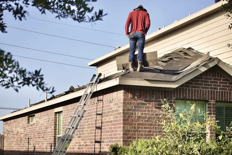 Professional roofer working on a residential roof in Plainsboro Center